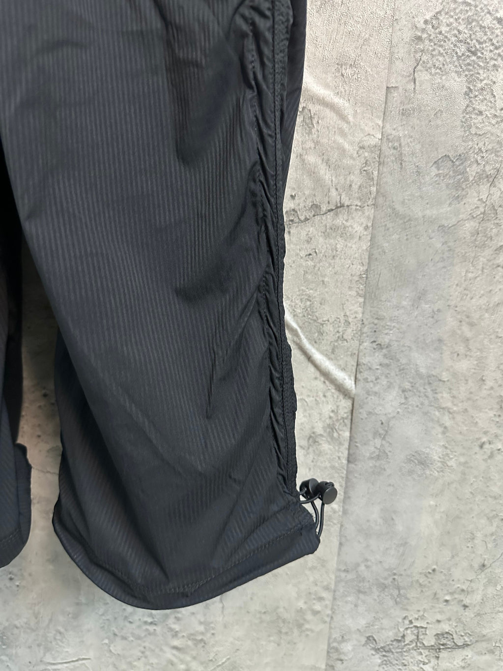 Black cargo pants side seam and ankle drawcord hem