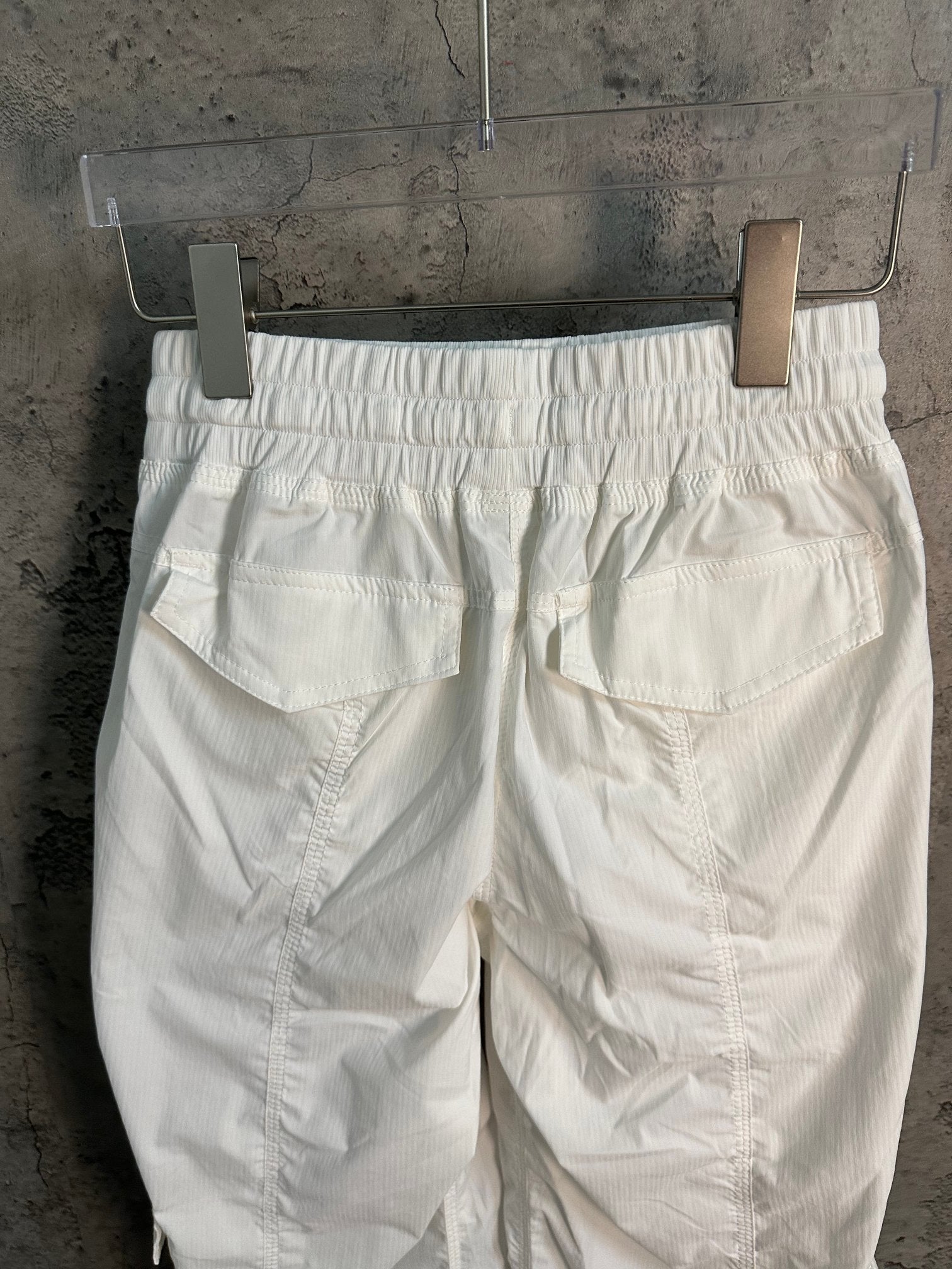 White cargo pants back view with two large patch pockets