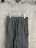 Dark gray cargo pants with elastic waist, front drawstring, and knee patch pockets