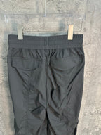 Dark gray cargo pants back view with pleated design and patch pockets