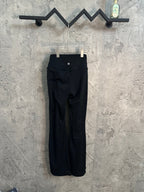 Black pants with front button detail, pockets, and pull-on waistband