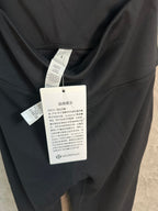 Black pants with attached size and care tags on the waistband