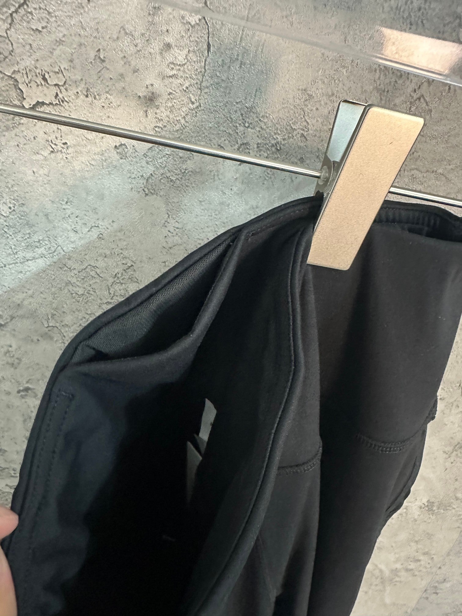 Black trousers fabric fold and side panel seam