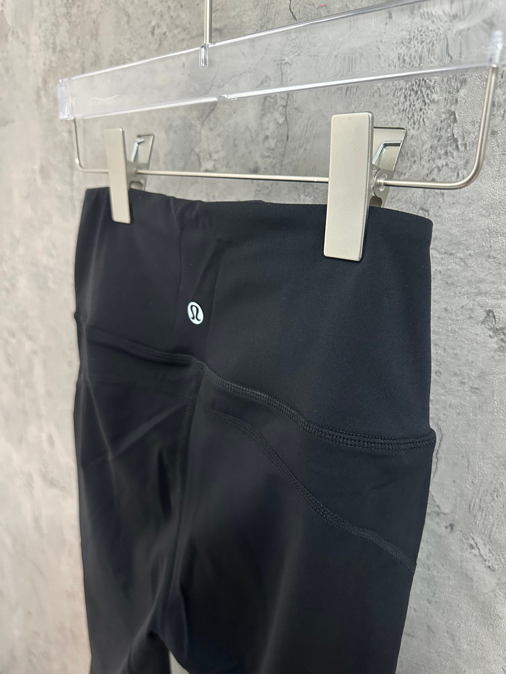 Black leggings-style trousers with curved side seam