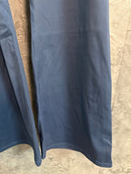Blue athletic pants lower leg and hem with stitched edge and drape