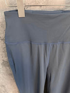 Blue athletic pants close-up of waistband and stitched front seam