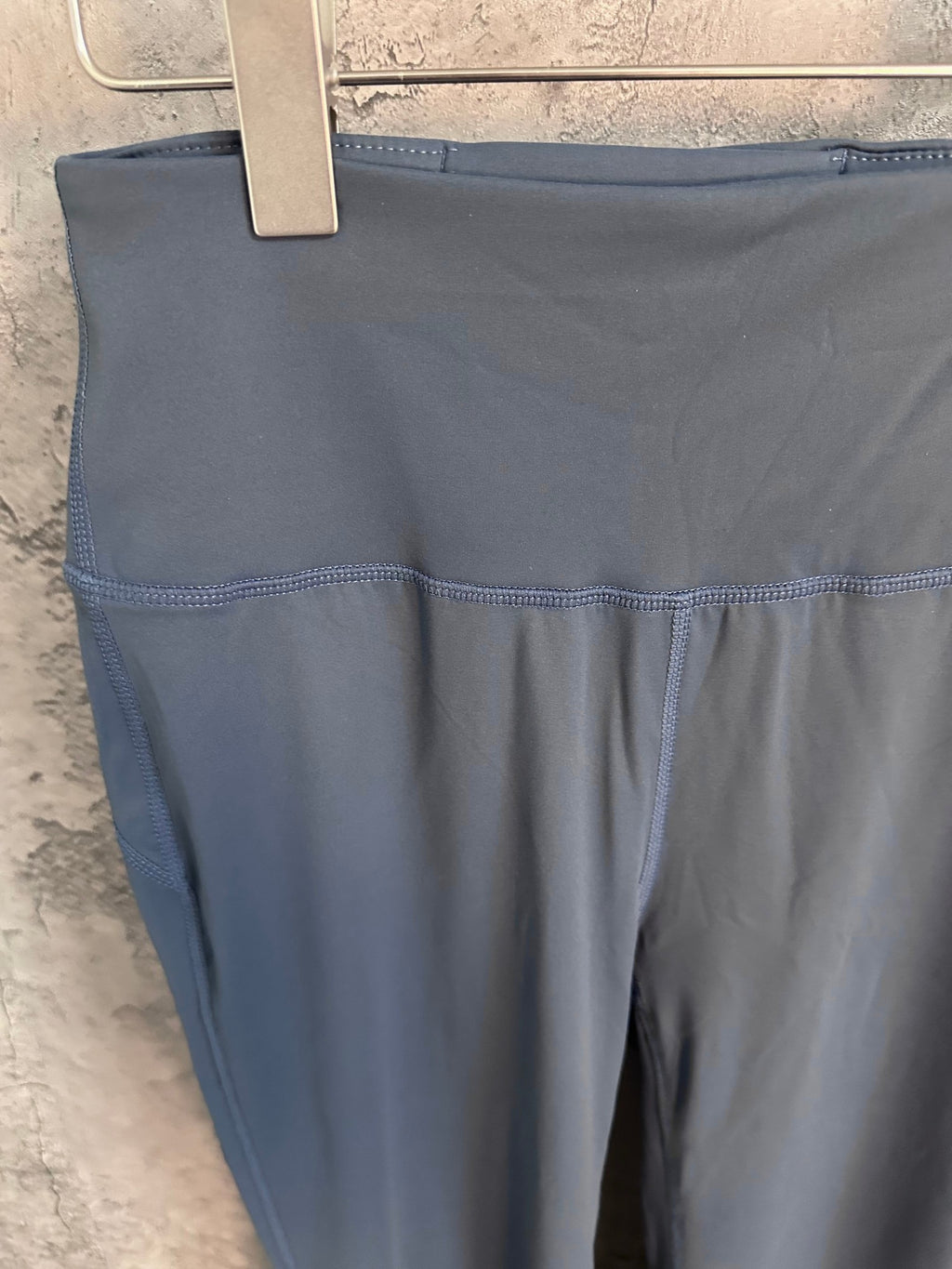 Blue pants close-up of upper leg and side panel with visible stitching