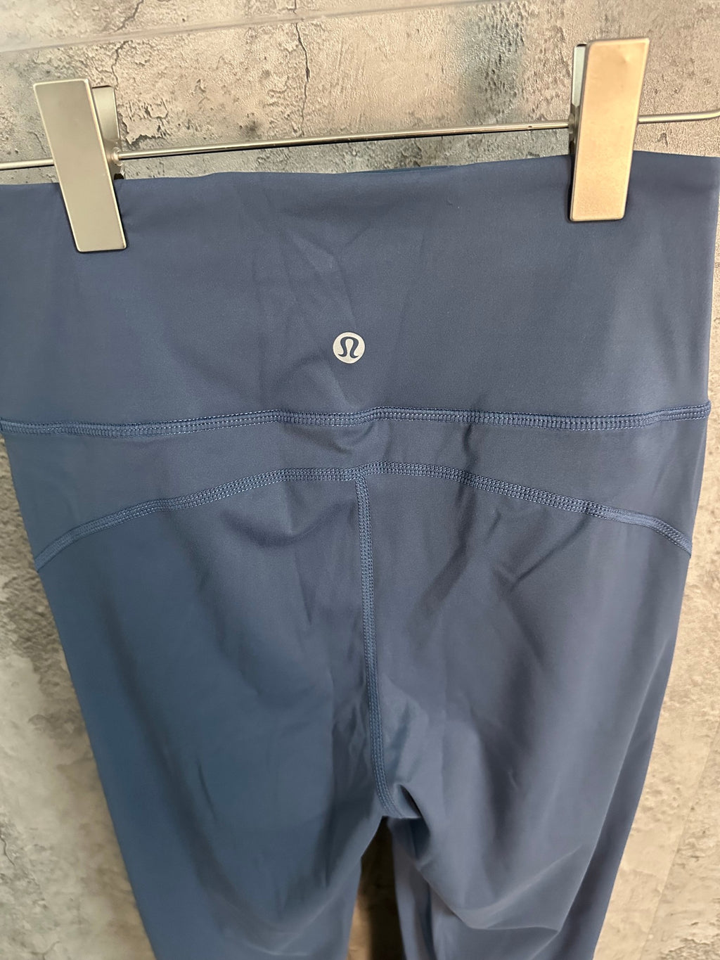 Blue leggings with small chest-logo detail at center of waistband