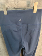 Blue leggings with small chest-logo detail at center of waistband