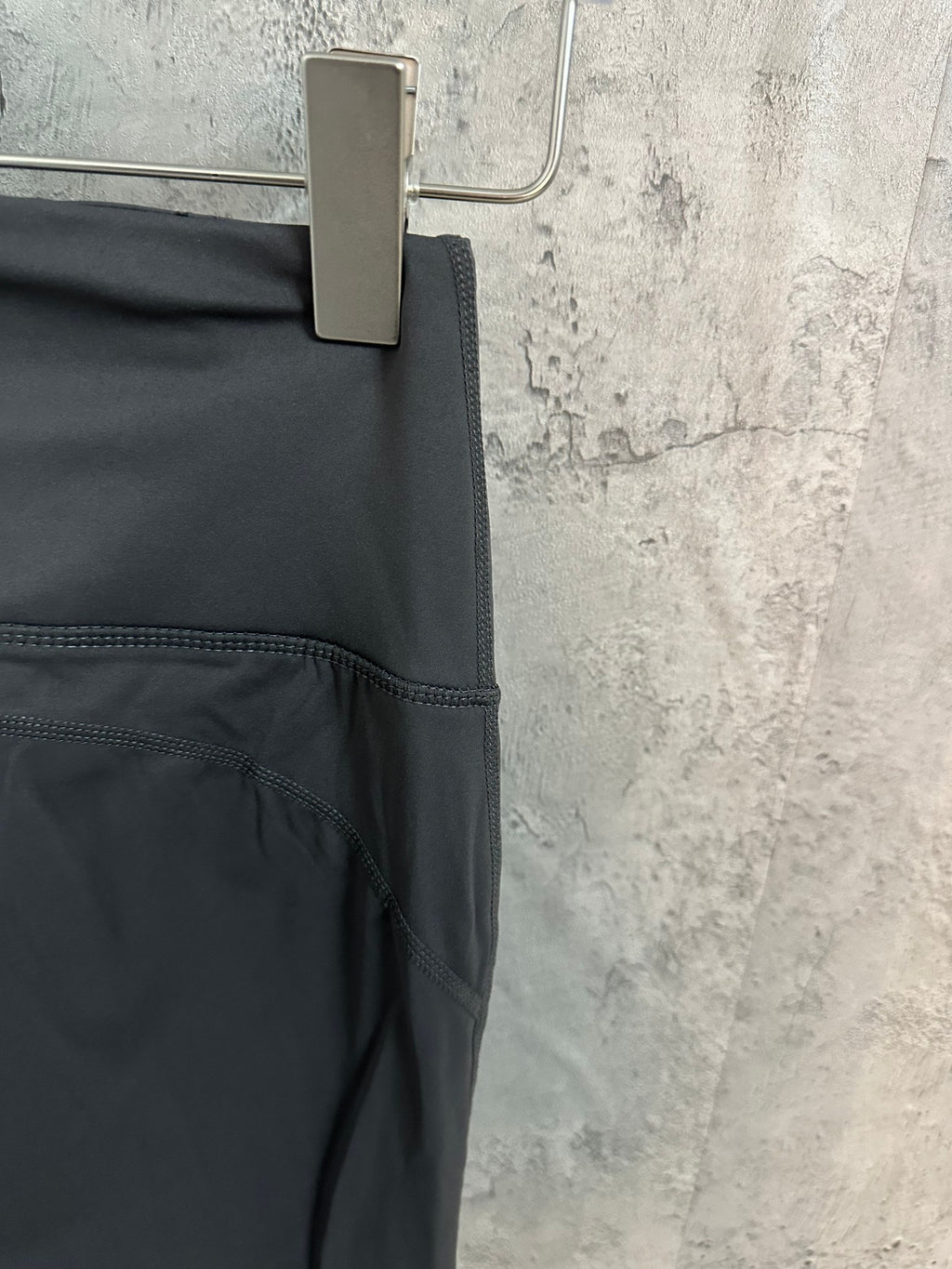 Dark gray pants with curved seam detail and side pocket