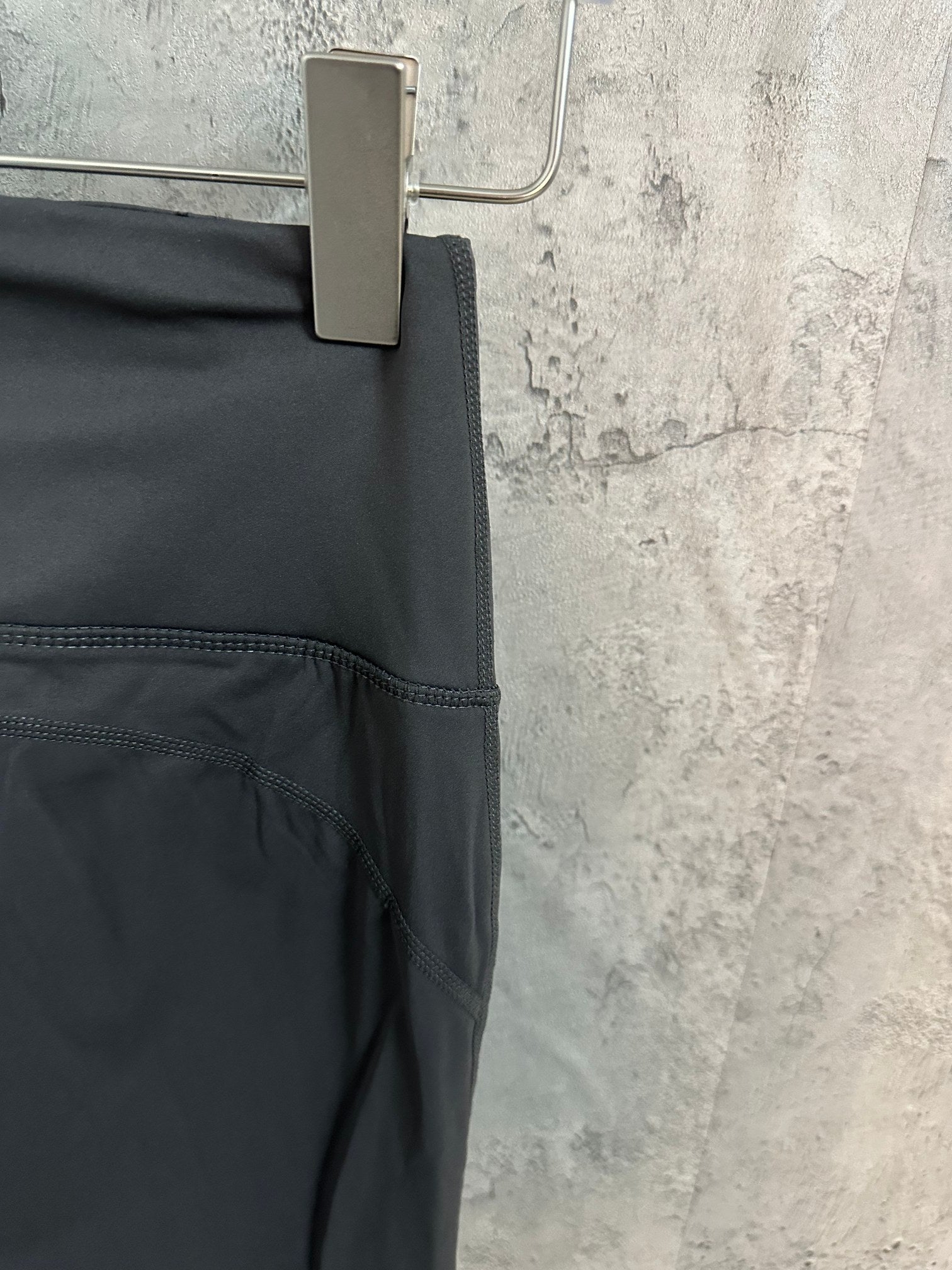 Dark gray pants with curved seam detail and side pocket