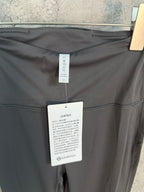 Charcoal pants with care label and size tag inside waistband