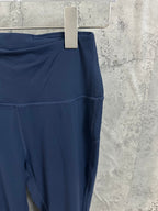 Navy athletic pants side view, midsection seam and smooth stretch fabric