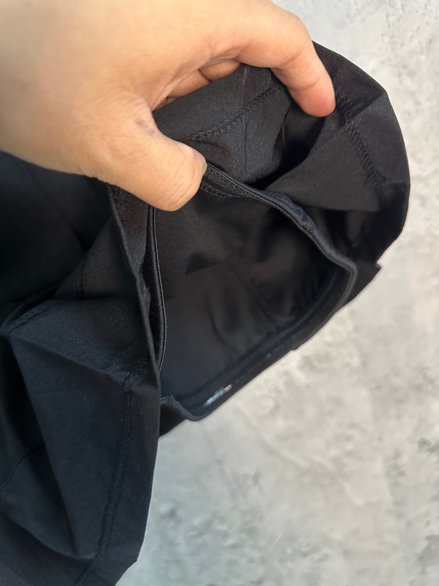 Black skort with hand-part opening showing inner lining and seams