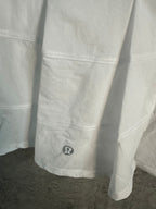 White skirt side panel with logo patch near hem