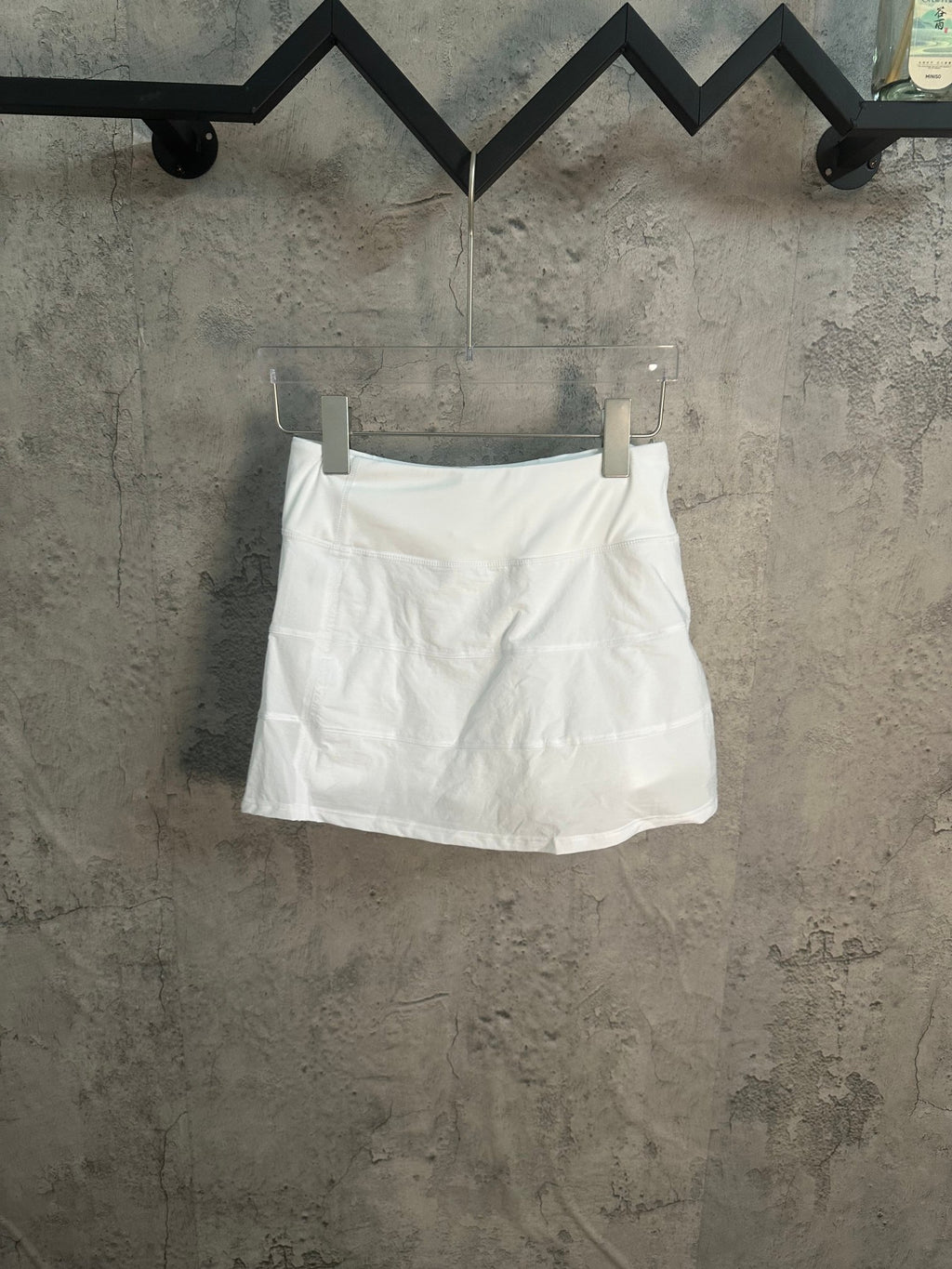 White A-line skirt with pleated front and elastic waistband