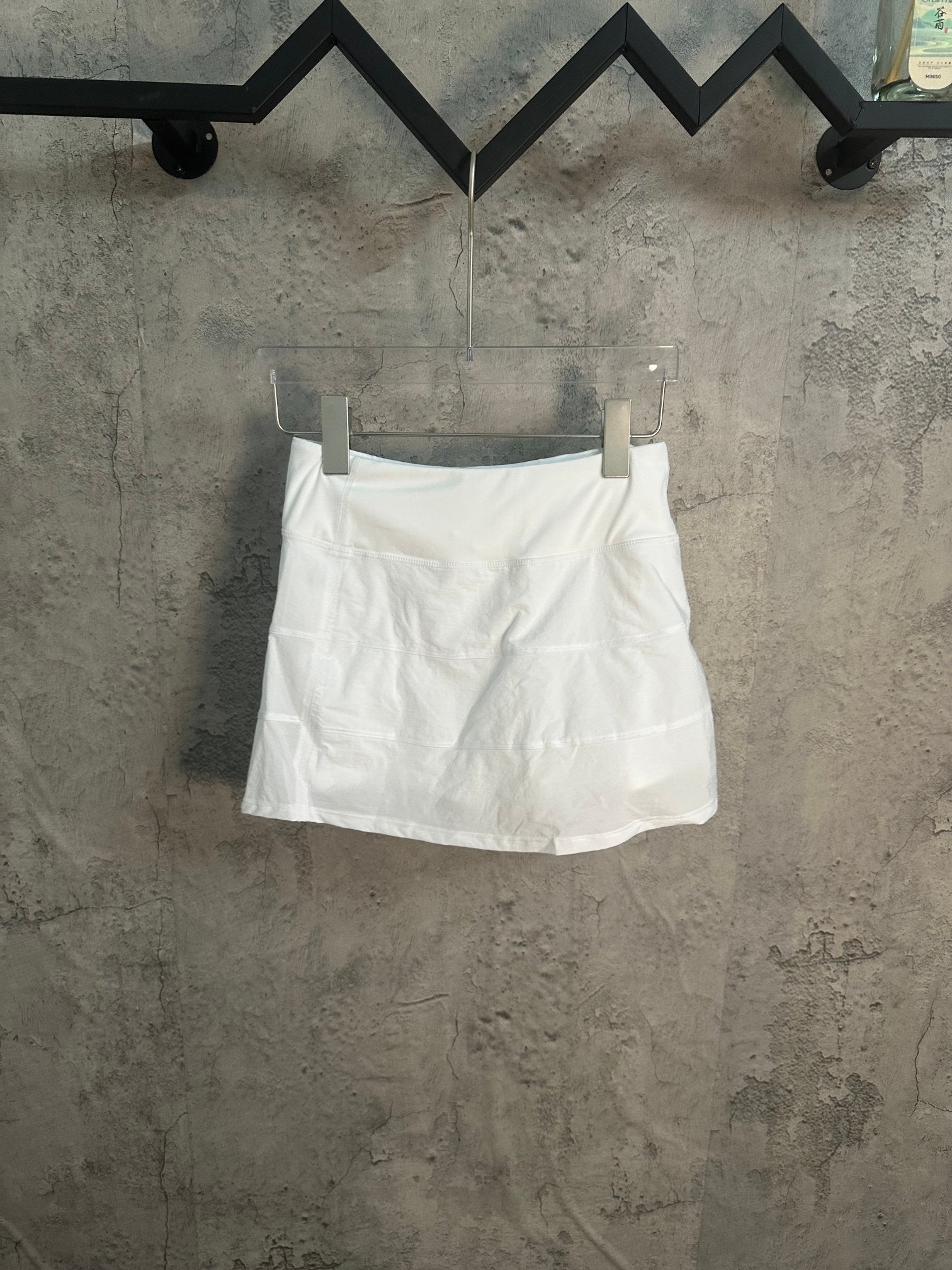 White A-line skirt with pleated front and elastic waistband
