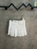 White pleated skirt with layered panels and elastic waistband