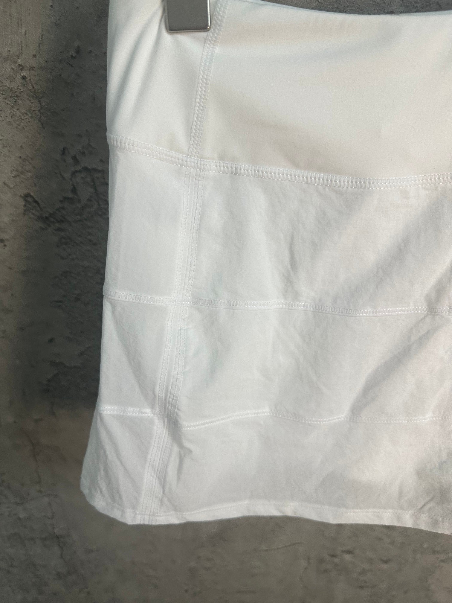 White skirt with stitched waistband and tiered pleats