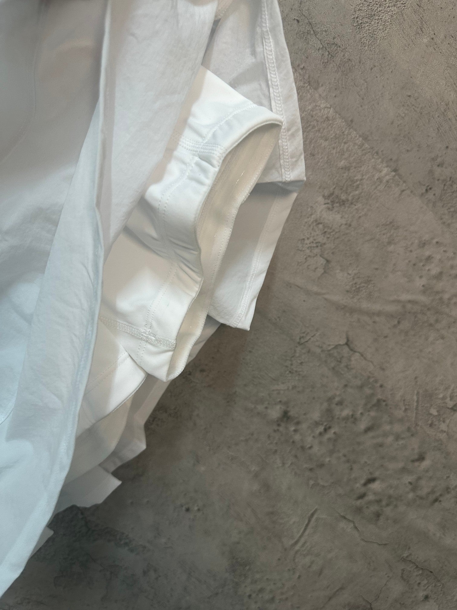 White skirt with overlapping panels and side seam detail