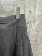 Ralph Lauren skirt side view with stitched seams and tiered panels, dark gray