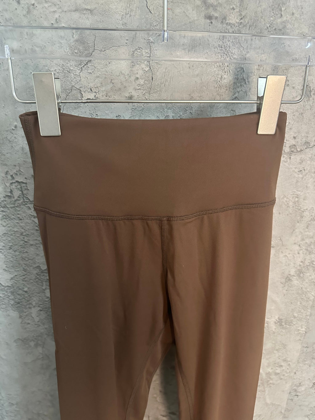 Brown athletic pants waistband and front seam detail, flat view