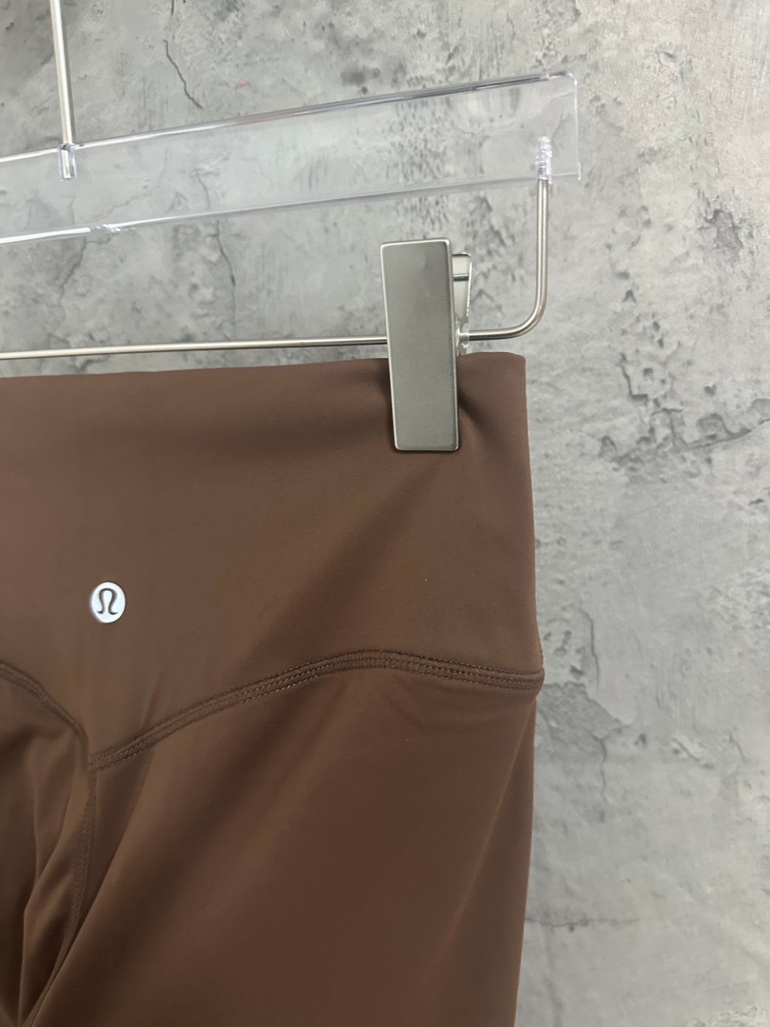 Brown pants with stitched waistband and logo at side