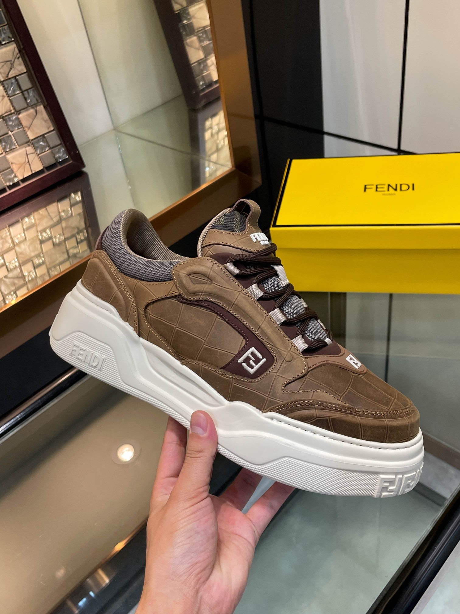 Brown Fendi sneakers with chunky white sole, lace-up, logo on strap
