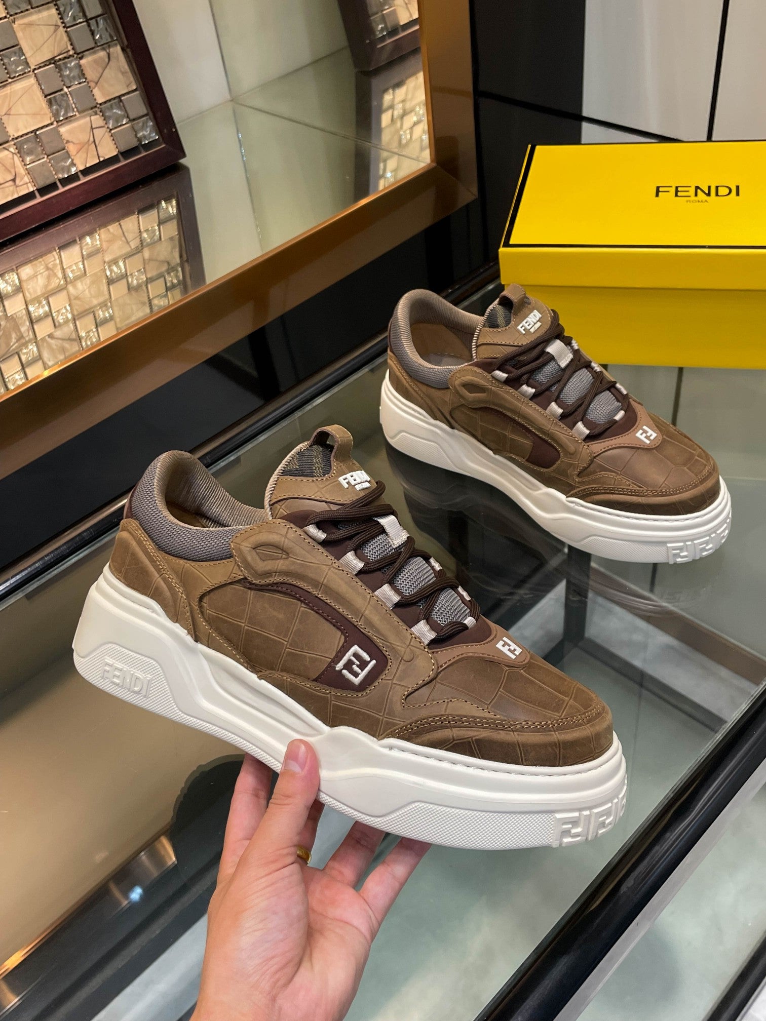 Brown Fendi lace-up sneakers with white platform sole and dark gray trim