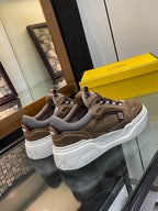 Pair of brown Fendi sneakers with gray lining and chunky white soles