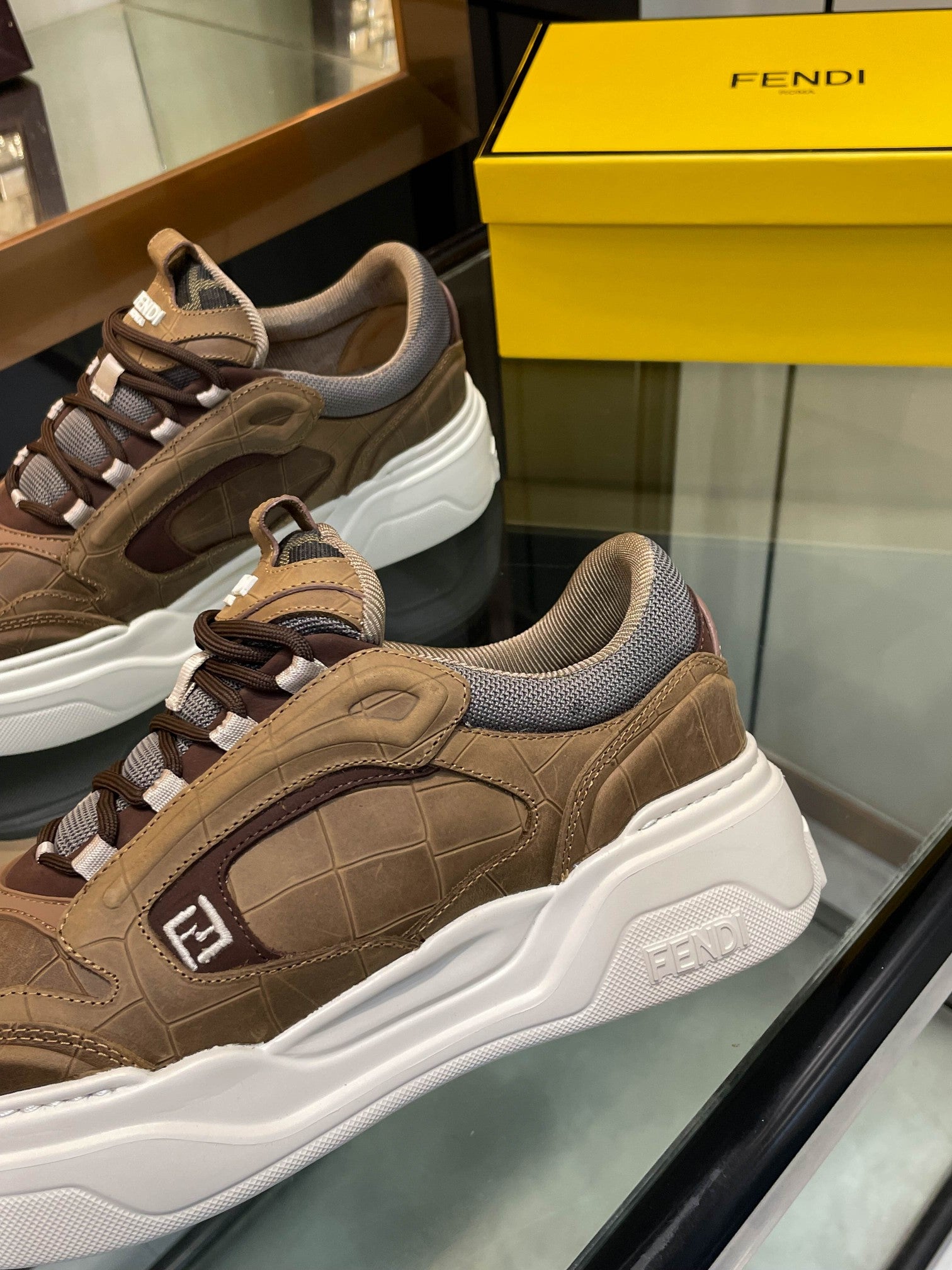 Brown Fendi sneakers with lace-up front, white midsole, textured panels