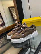 Brown Fendi lace-up sneakers with chunky white sole and gray fabric panels