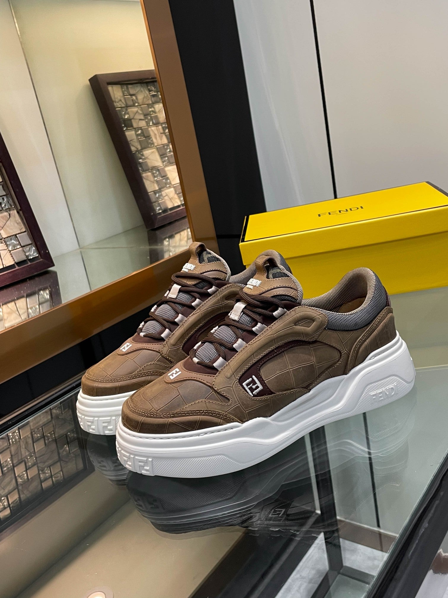 Brown Fendi lace-up sneakers with chunky white sole and gray fabric panels