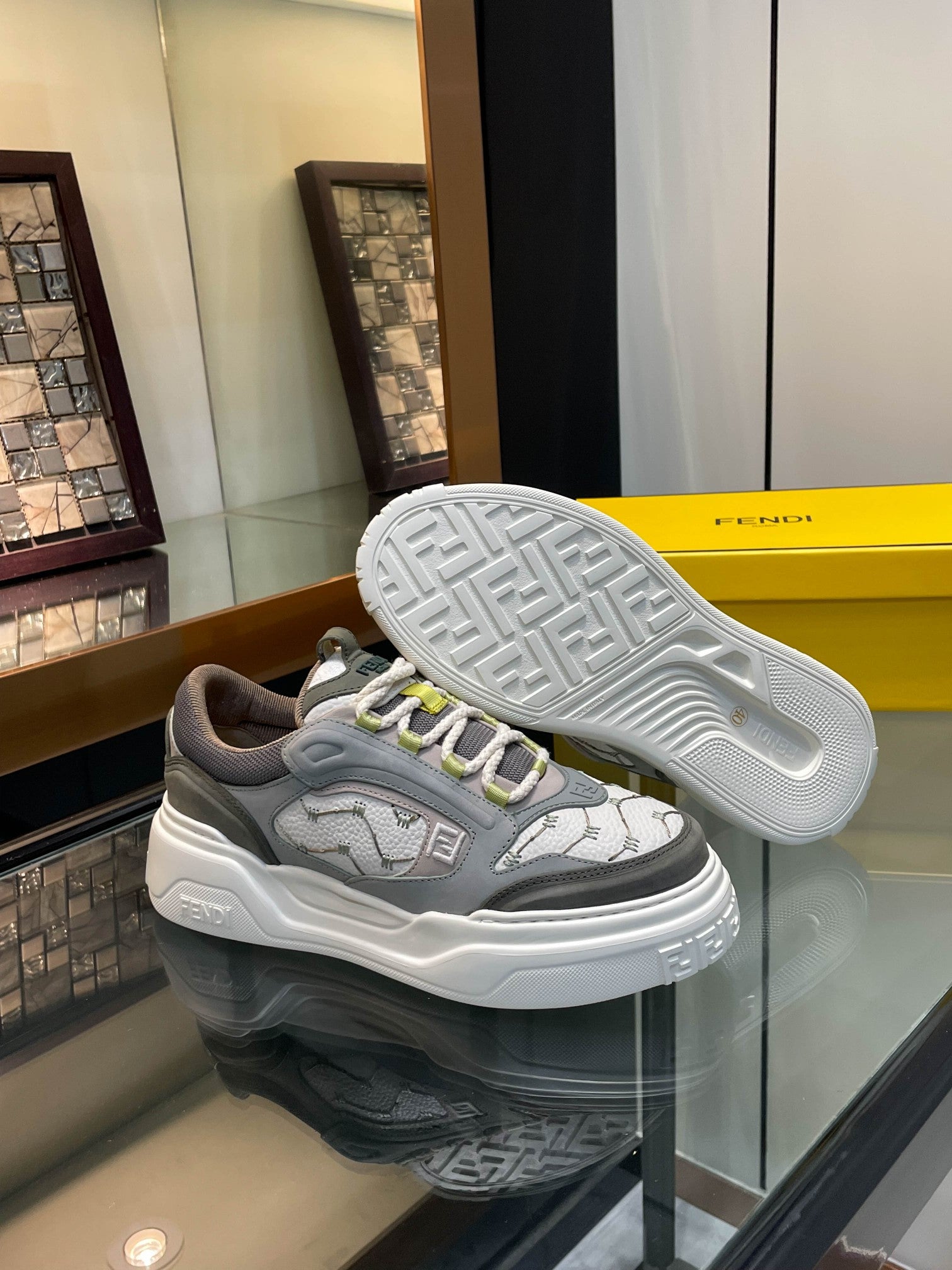 Gray unisex sneakers showing white outsole tread and lime-accented upper