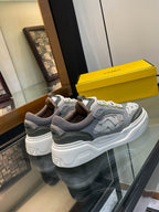 Gray unisex lace-up sneakers with white chunky sole and lime logo accents, side view