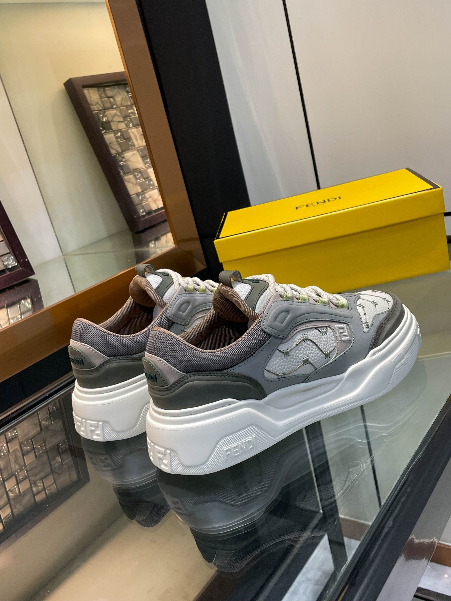 Gray unisex lace-up sneakers with white chunky sole and lime logo accents, side view