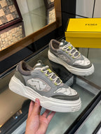 Gray unisex lace-up sneakers with white chunky sole and lime eyelets, side view