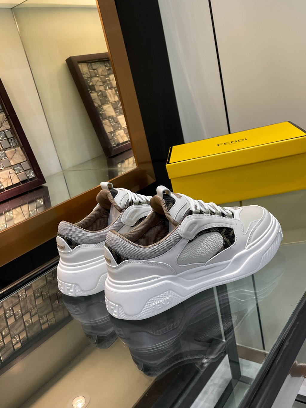 Pair of white and gray lace-up sneakers with padded collars and thick soles