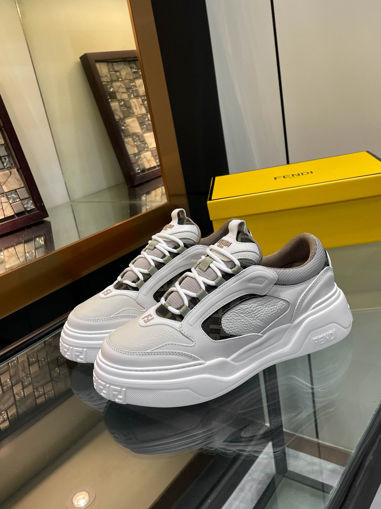 White and gray chunky sneakers with lace-up front and dark side logo panel