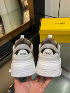Back view of white and gray sneakers showing heel logo and pull-tab detail