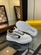 White and gray sneakers with textured outsole tread and lace-up upper