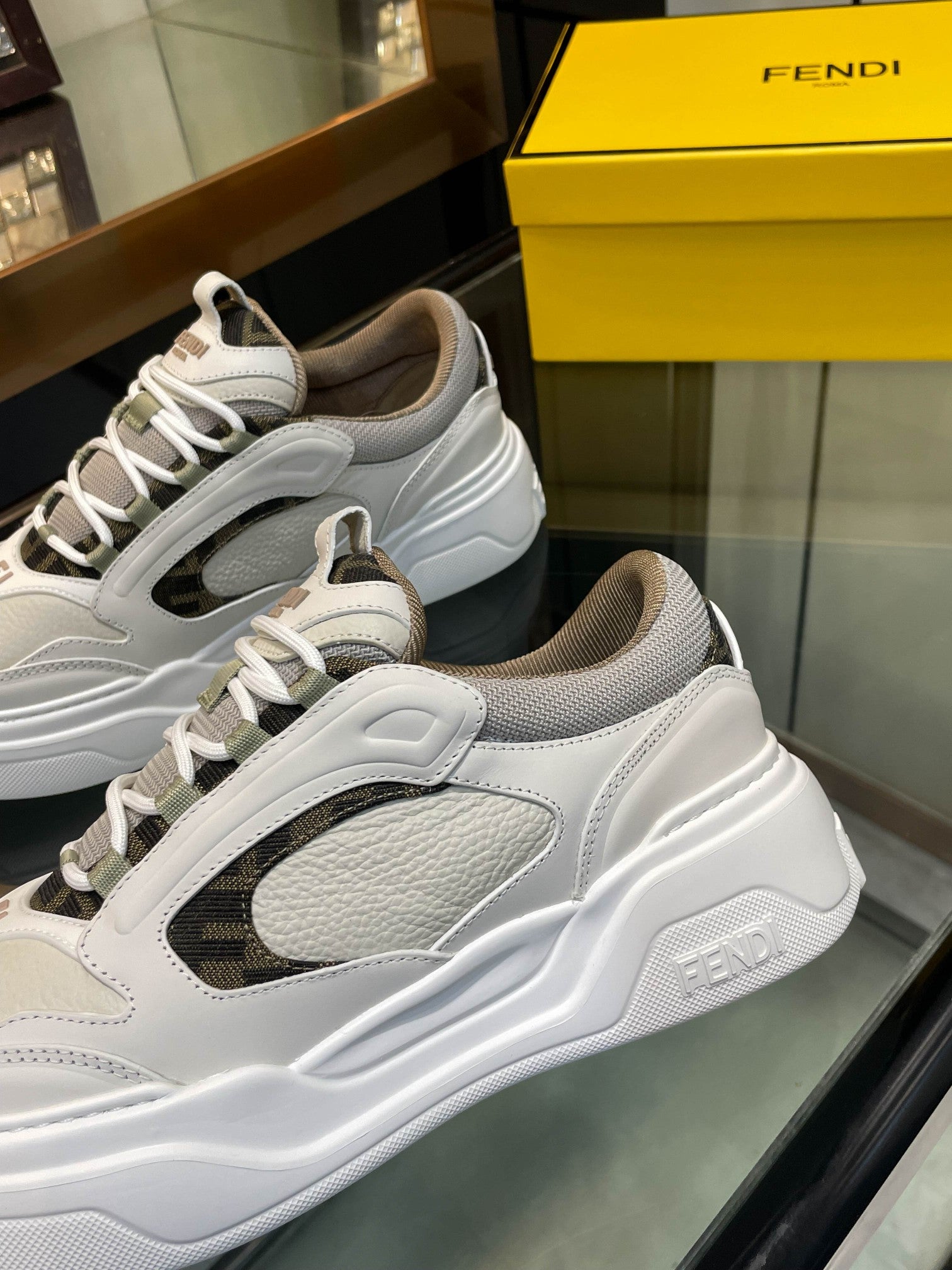 Close-up of white and gray lace-up sneaker with mesh side panel and stitching