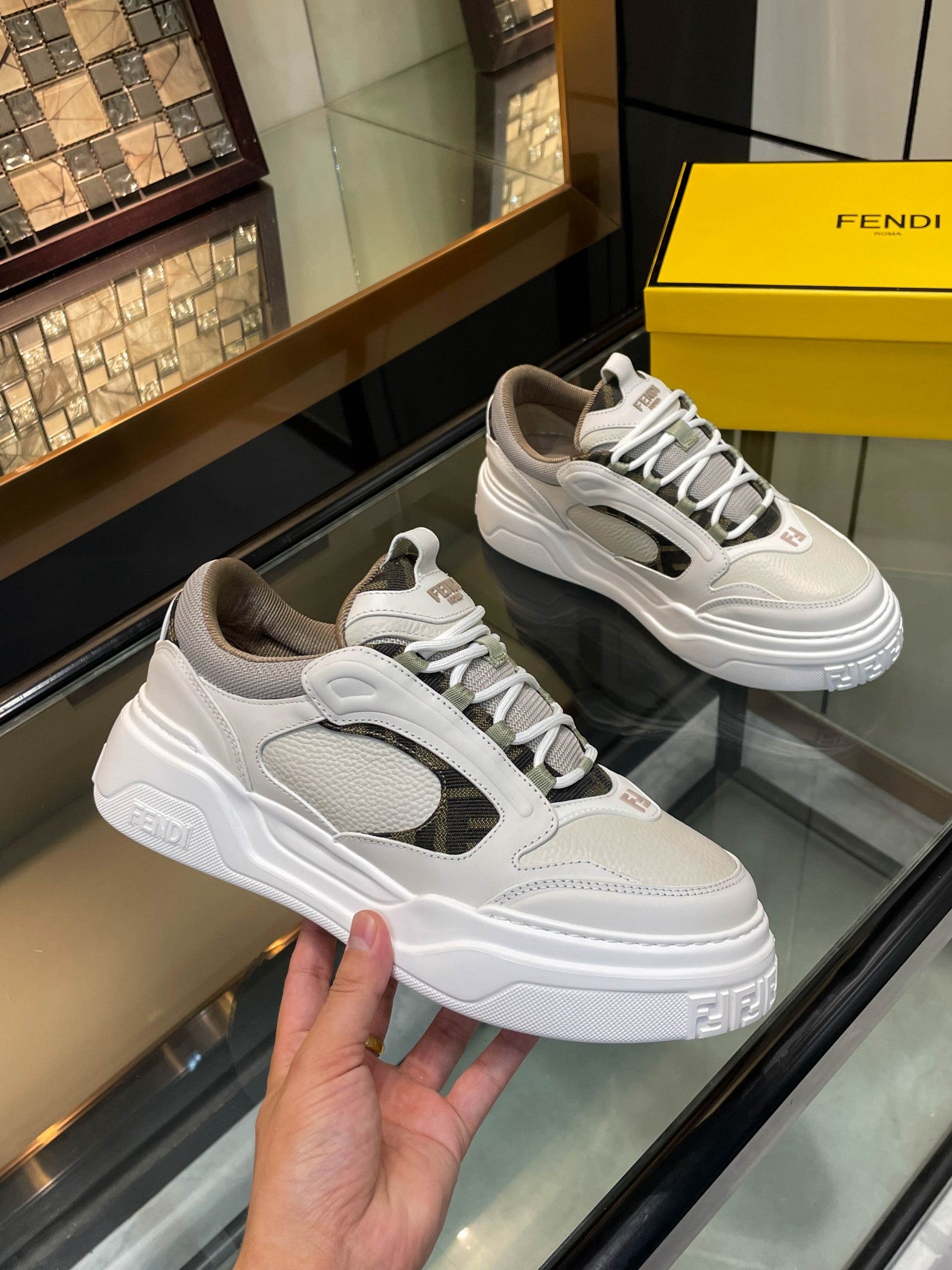 White and gray lace-up sneakers with textured panels and chunky white sole