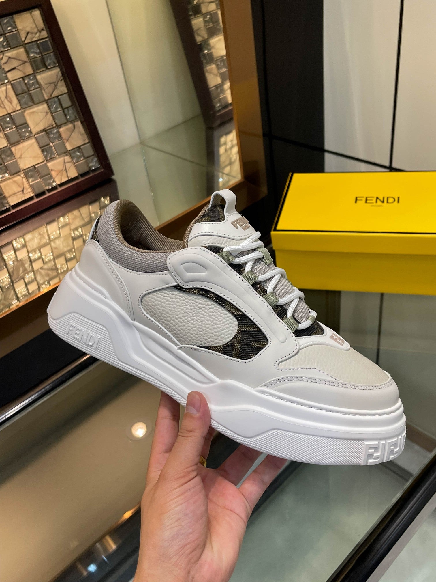 White and gray lace-up sneaker with dark logo details and grippy textured sole