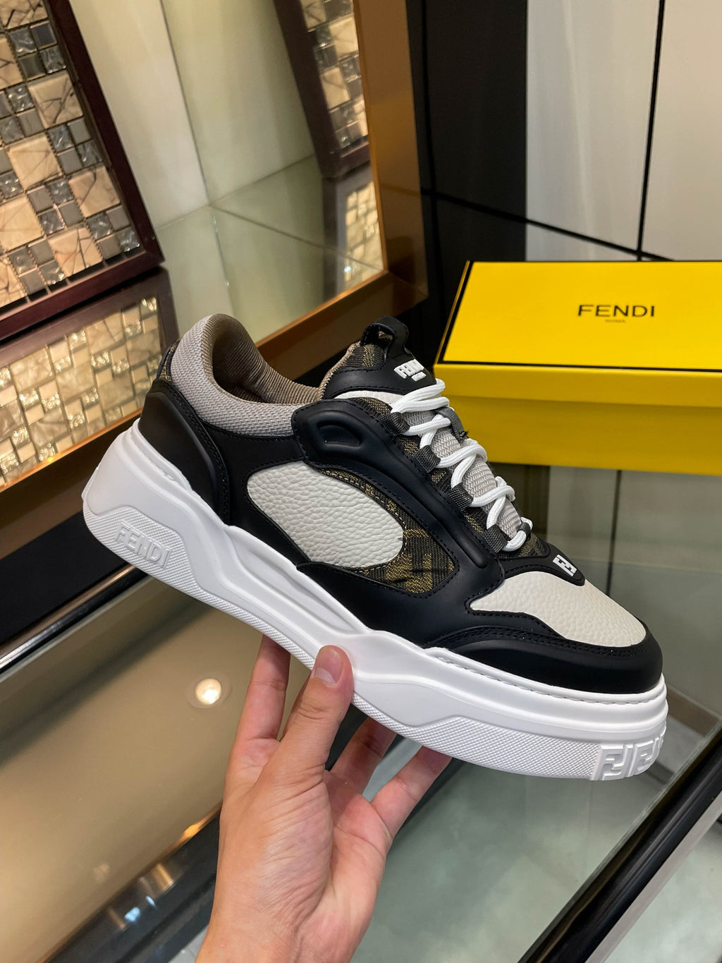 Dark and white unisex sneakers with lace-up front and molded rubber sole