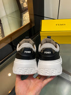 Back view of dark unisex sneakers with FENDI heel tabs and chunky white tread