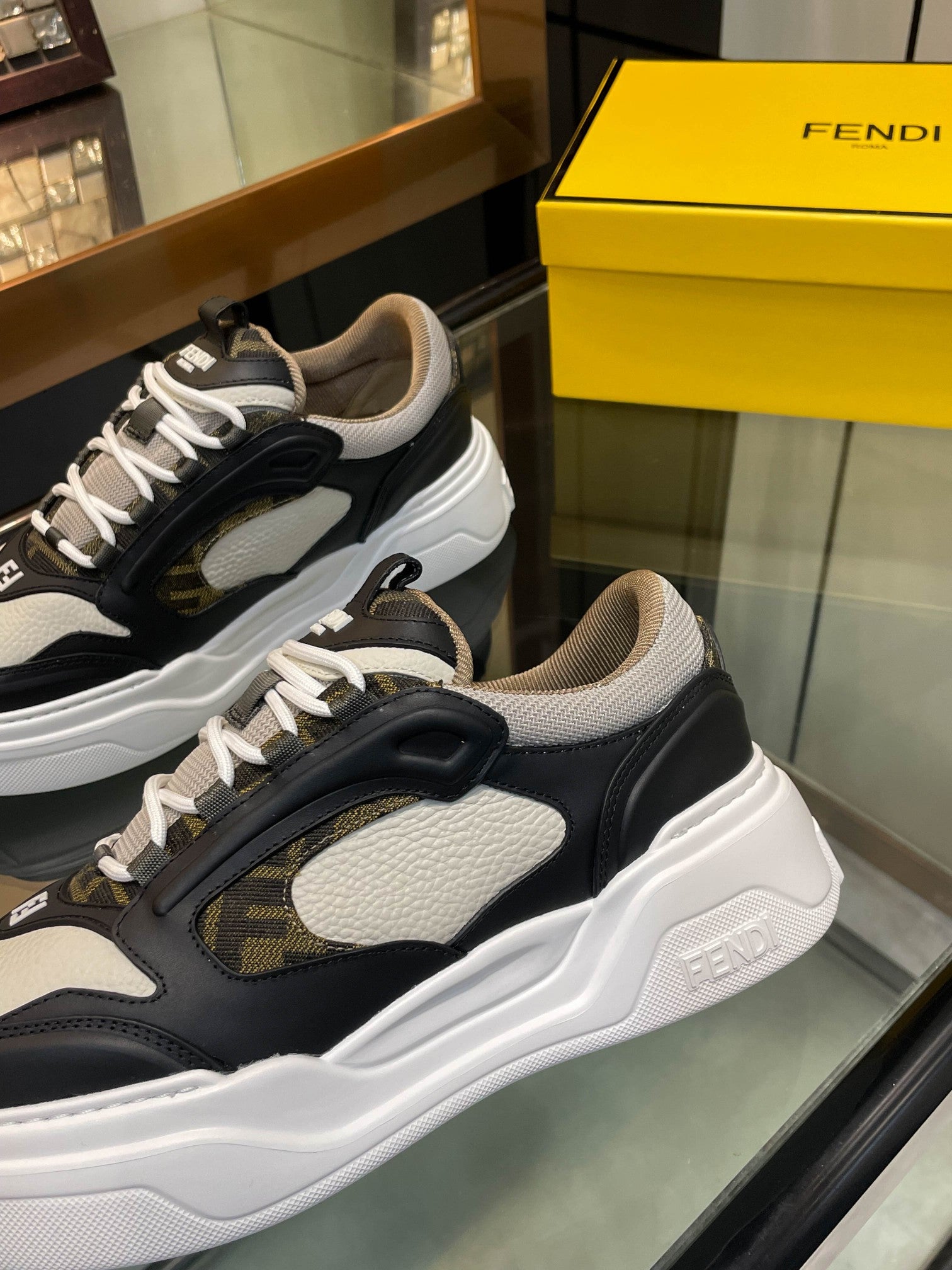 Close-up of dark and white unisex sneakers, lace-up with logo patch details