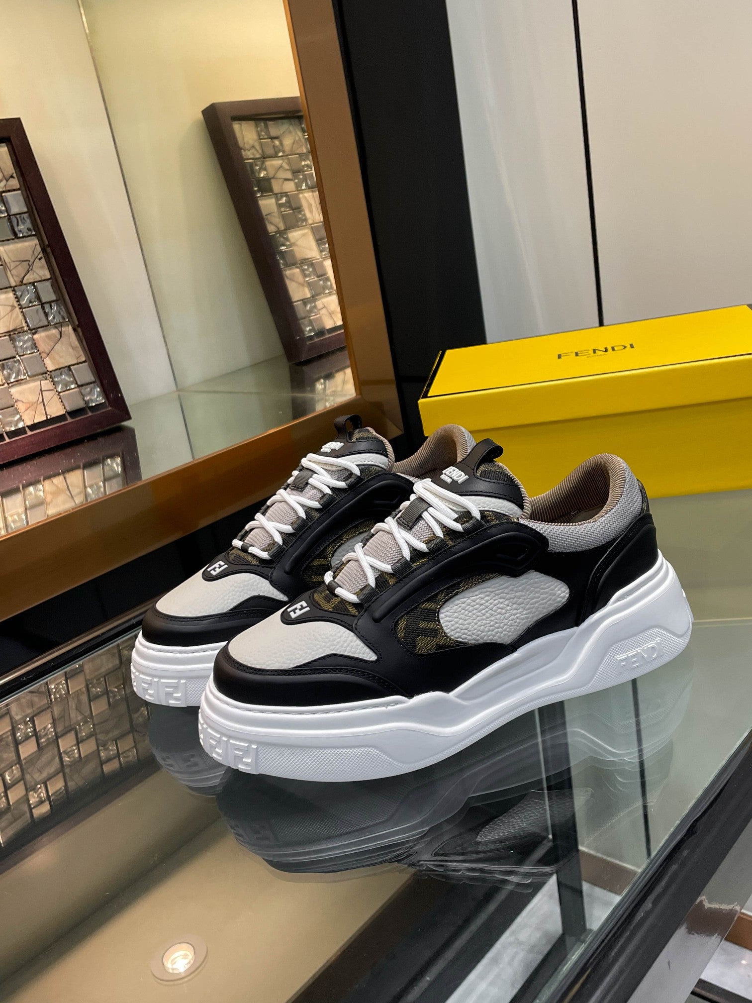 Black and white unisex sneakers with chunky white sole and lace-up front