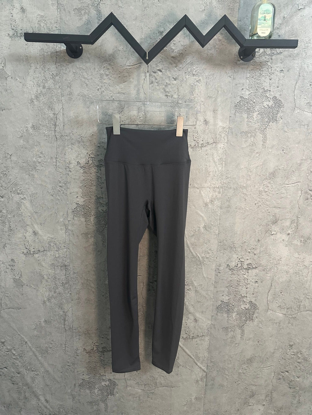 Black slim-fit pants with waistband and front opening seam