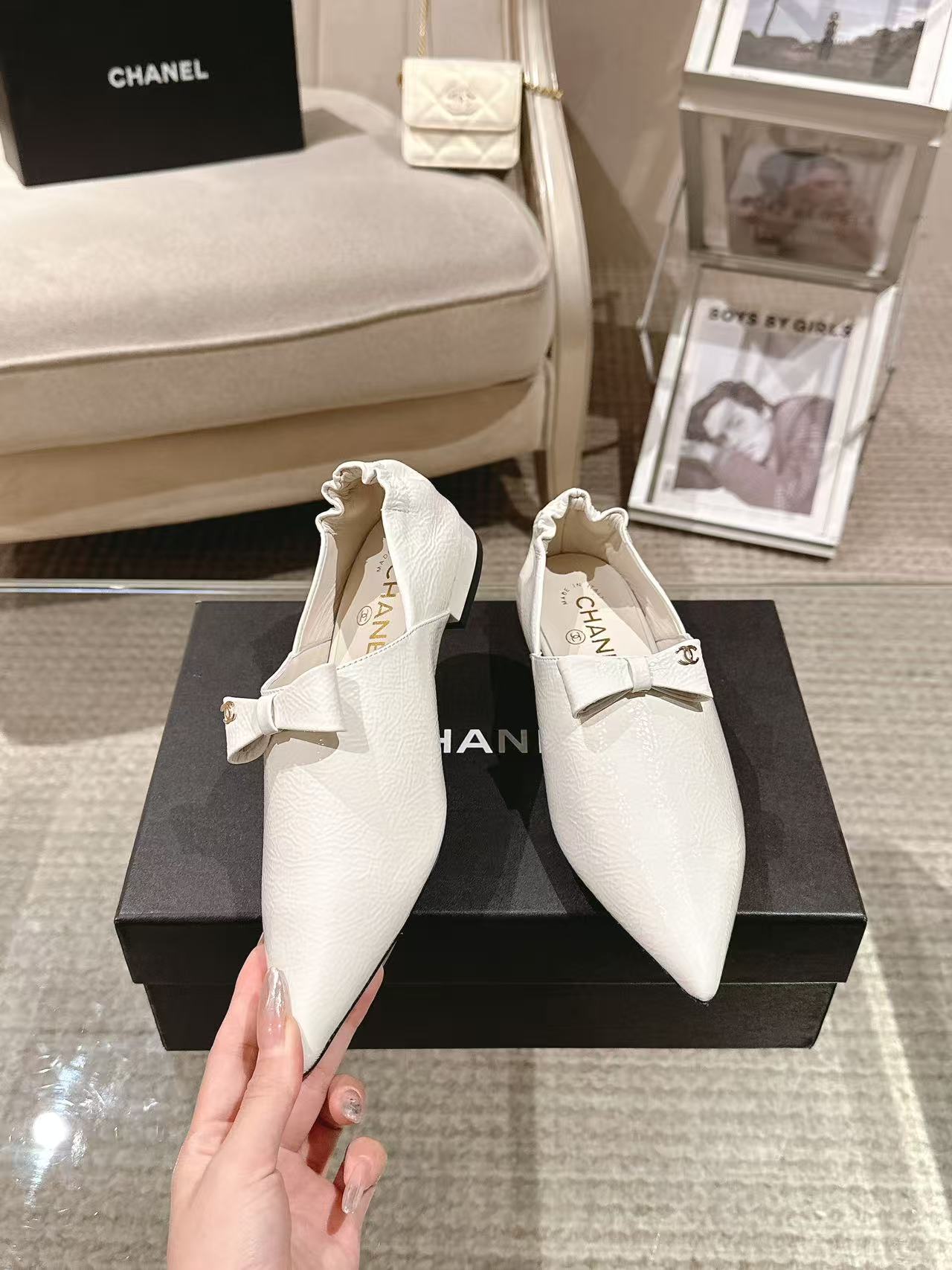 White leather pointed-toe flats with bow strap and textured finish